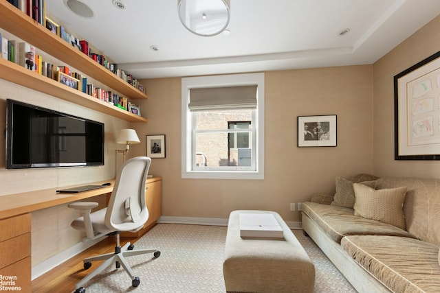 office area with baseboards and built in study area