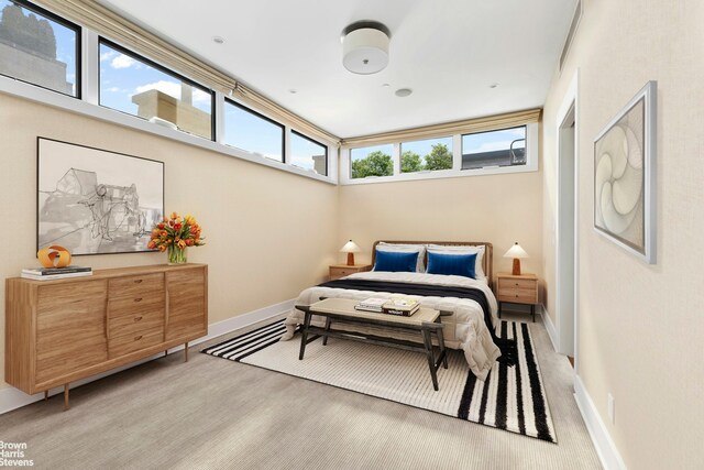 bedroom with light wood-style flooring and baseboards