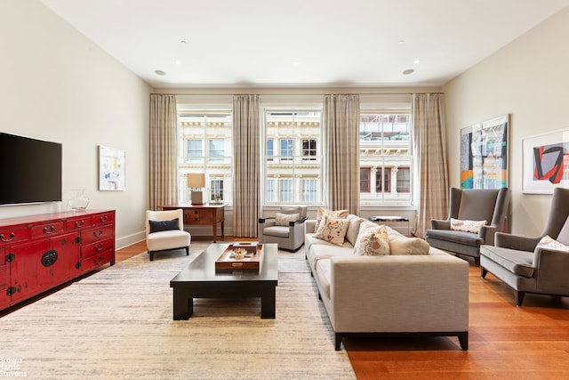 living area featuring recessed lighting, baseboards, and wood finished floors