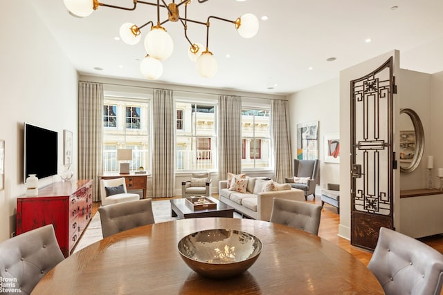 dining area with recessed lighting, a chandelier, and wood finished floors