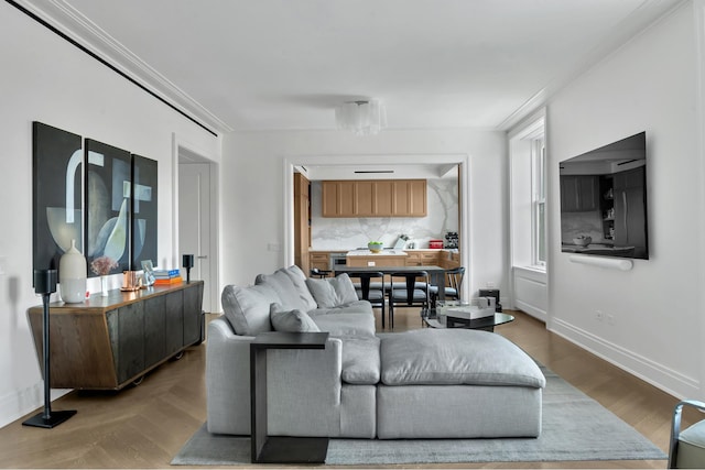 living room with crown molding and baseboards