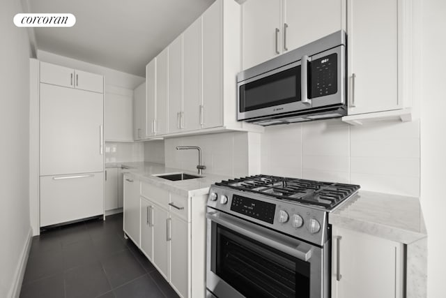 kitchen with sink, white cabinetry, and stainless steel appliances