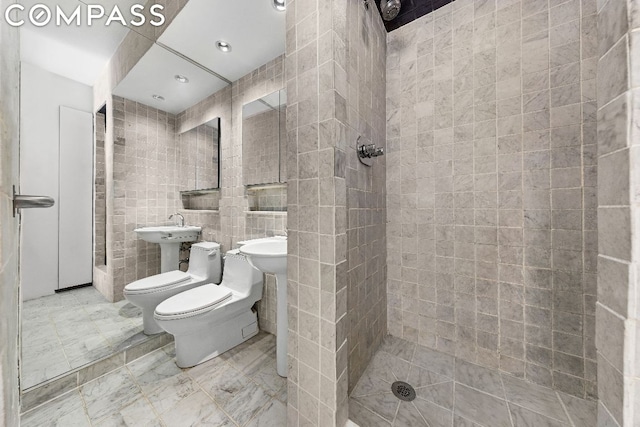 bathroom featuring a bidet, toilet, tile walls, and a tile shower