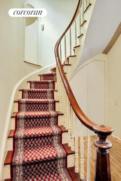 staircase featuring ornamental molding