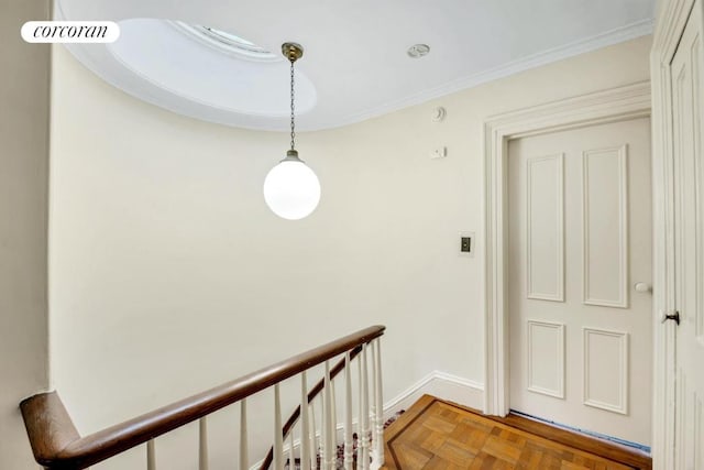 corridor featuring parquet floors and crown molding