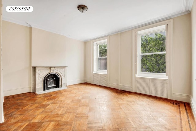 unfurnished living room with ornamental molding and light parquet flooring