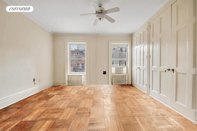 empty room with crown molding, visible vents, ceiling fan, and radiator