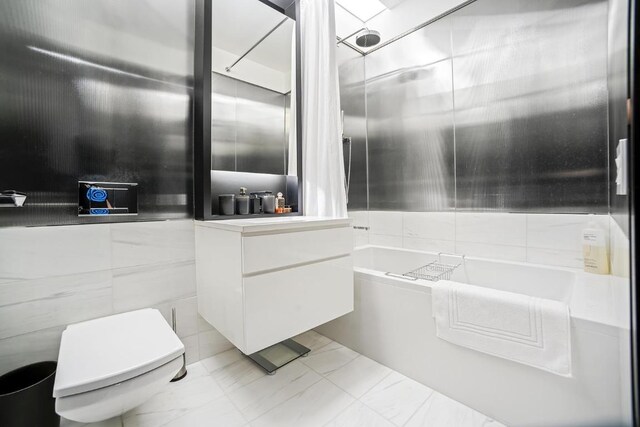 kitchen with decorative light fixtures, white cabinetry, sink, a wall of windows, and stainless steel appliances