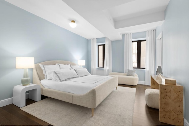 bedroom with dark wood-type flooring