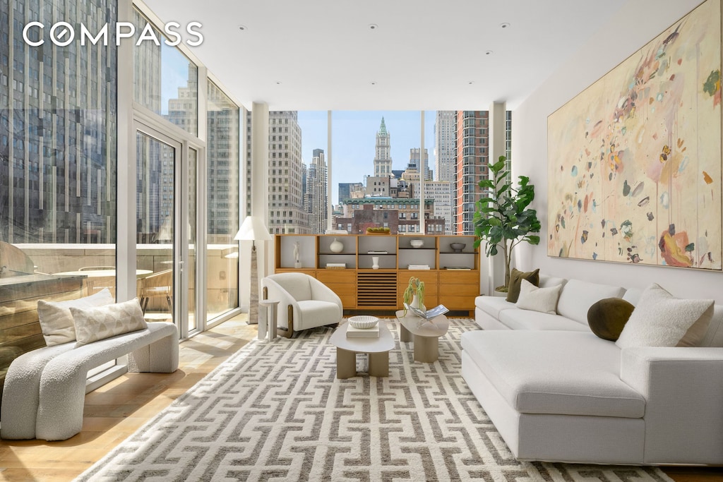 interior space with a view of city, wood finished floors, and floor to ceiling windows