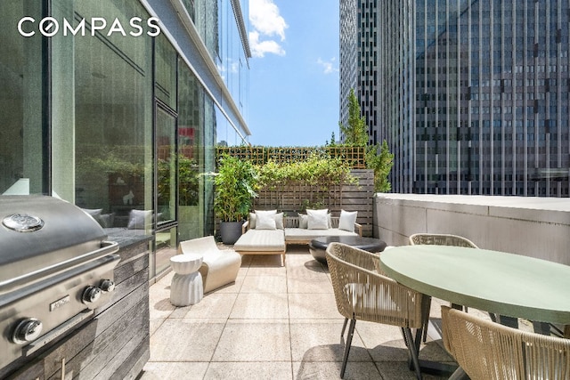 view of patio with area for grilling, an outdoor hangout area, and grilling area