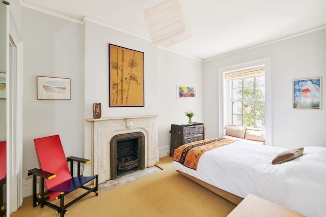 carpeted bedroom featuring a premium fireplace and crown molding