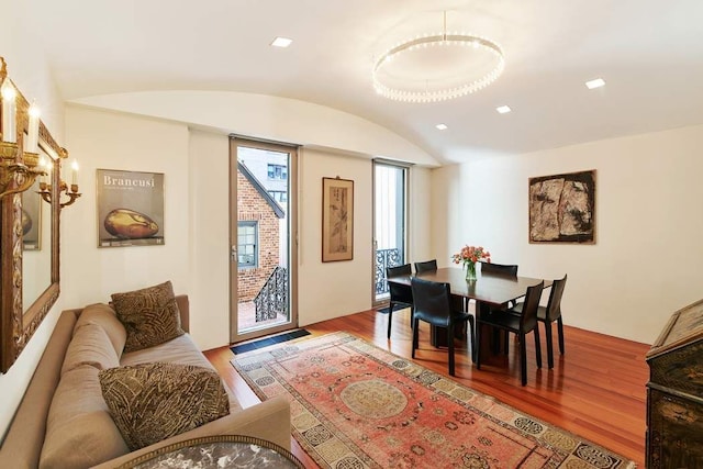 dining room with lofted ceiling, recessed lighting, and wood finished floors