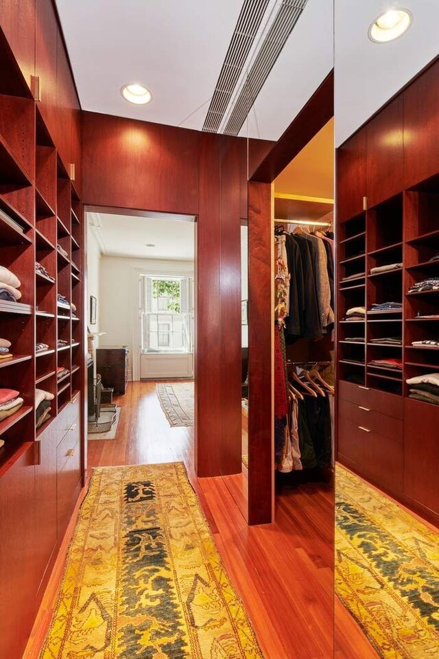 walk in closet featuring wood finished floors and visible vents