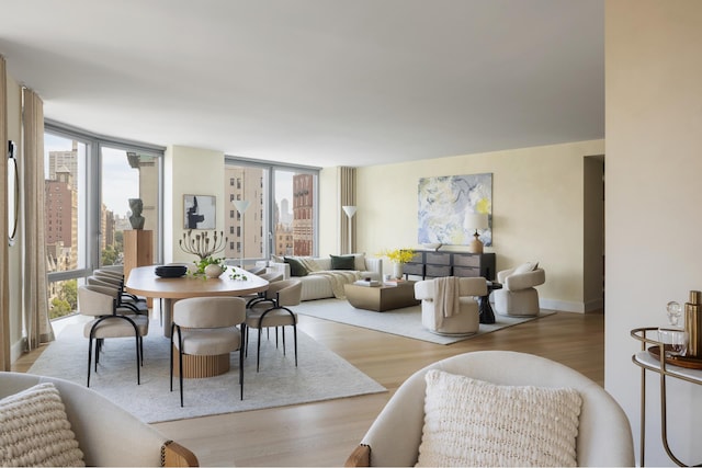 dining room featuring wood finished floors, a wealth of natural light, and baseboards