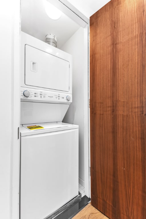 laundry area with stacked washer / drying machine