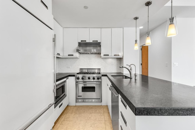 kitchen with decorative light fixtures, sink, appliances with stainless steel finishes, white cabinets, and wall chimney exhaust hood