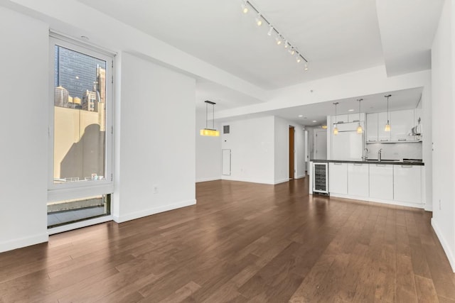 unfurnished living room with dark hardwood / wood-style floors and wine cooler