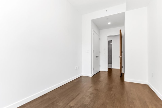 spare room featuring dark wood-type flooring