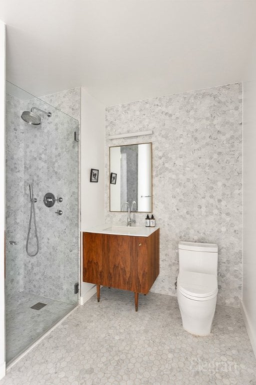 bathroom with vanity, toilet, and a walk in shower