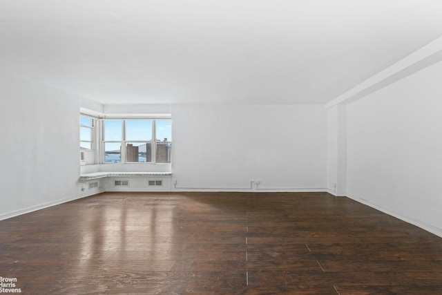 unfurnished living room featuring dark wood-type flooring