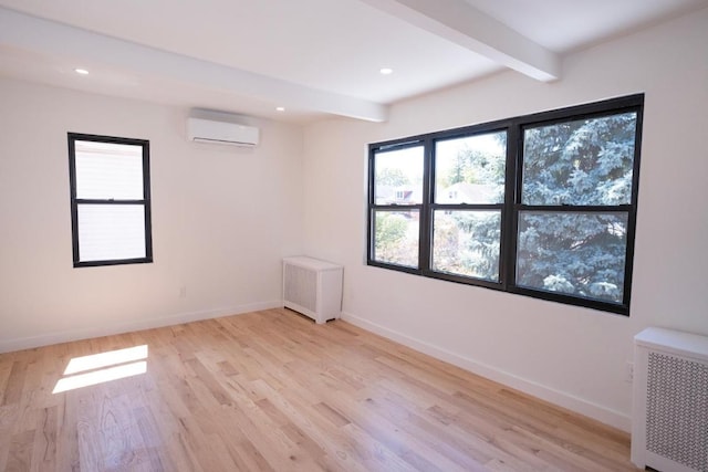 unfurnished room with radiator heating unit, an AC wall unit, beamed ceiling, and light wood-type flooring