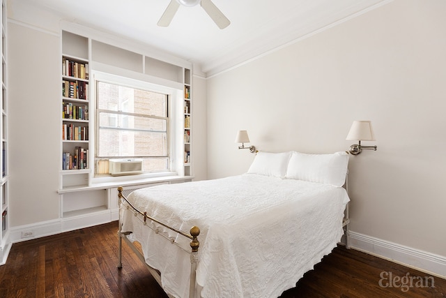 bedroom featuring baseboards, hardwood / wood-style flooring, ceiling fan, ornamental molding, and cooling unit