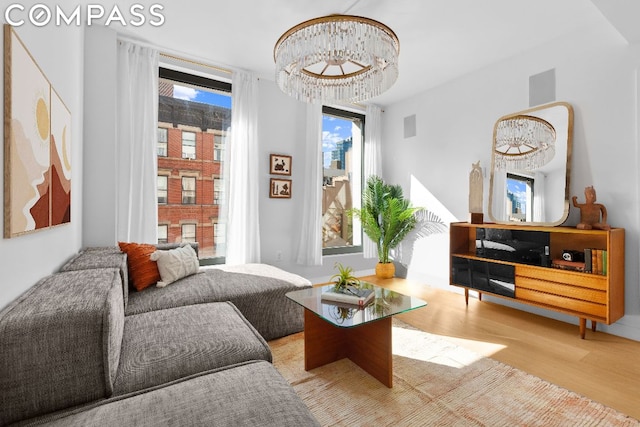 sitting room with a chandelier and light hardwood / wood-style floors