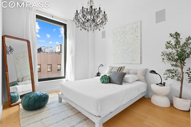 bedroom with a chandelier and hardwood / wood-style flooring