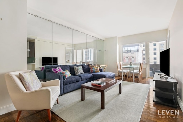 living room with track lighting and hardwood / wood-style flooring