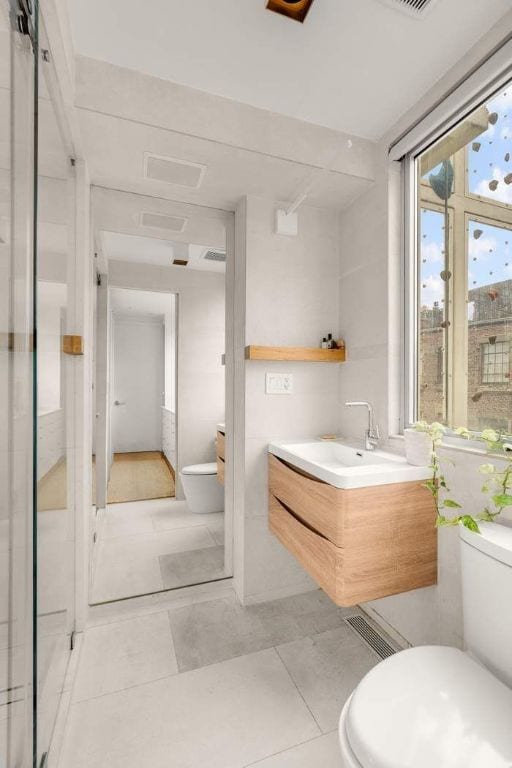 bathroom featuring vanity, tile patterned floors, and toilet