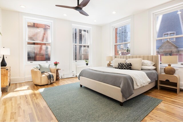 living room featuring wood-type flooring and built in features