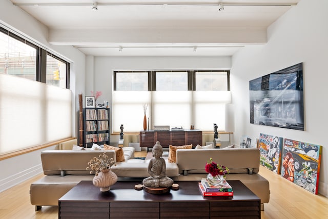 living room with beamed ceiling and hardwood / wood-style floors