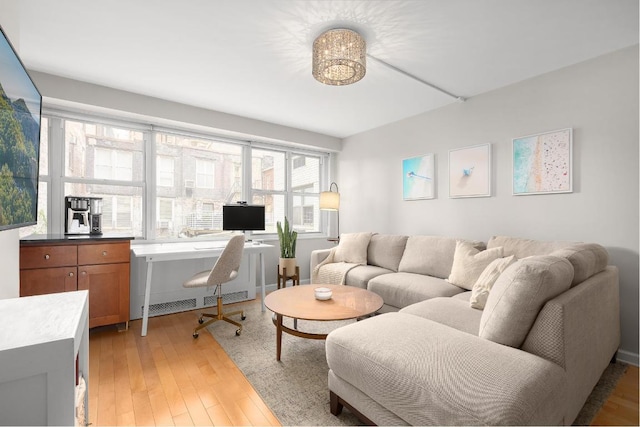 office area with hardwood / wood-style floors and radiator heating unit