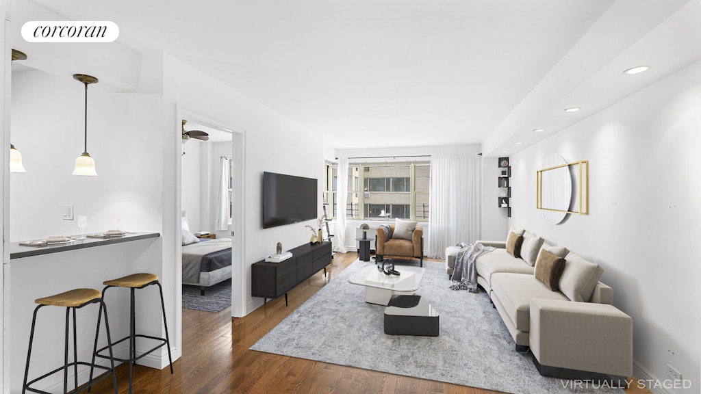 living room with wood finished floors, visible vents, and recessed lighting