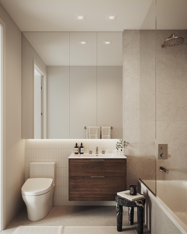 bathroom with vanity, tile walls, toilet, and a tub to relax in