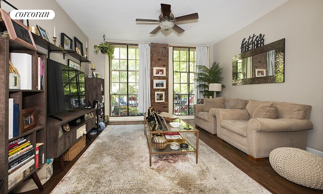 living room featuring ceiling fan and dark hardwood / wood-style floors