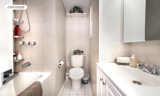 bathroom featuring tile walls, vanity, tile patterned floors, and a tub