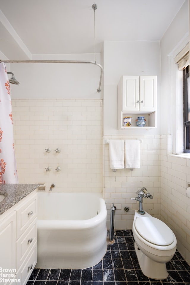 full bath featuring shower / tub combo with curtain, tile walls, and vanity