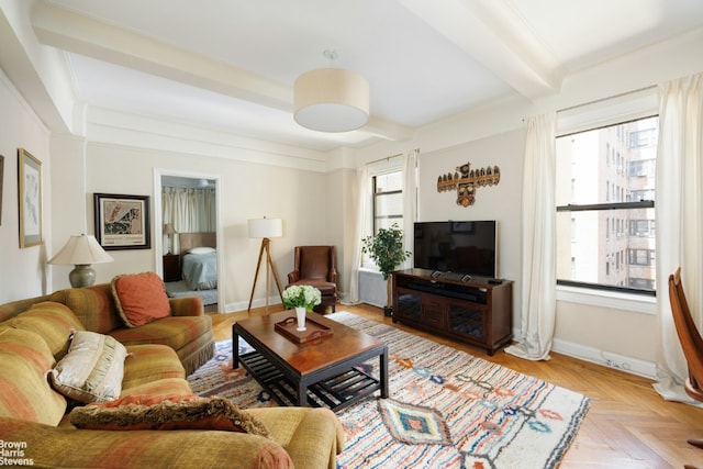 living room with beam ceiling and light parquet floors