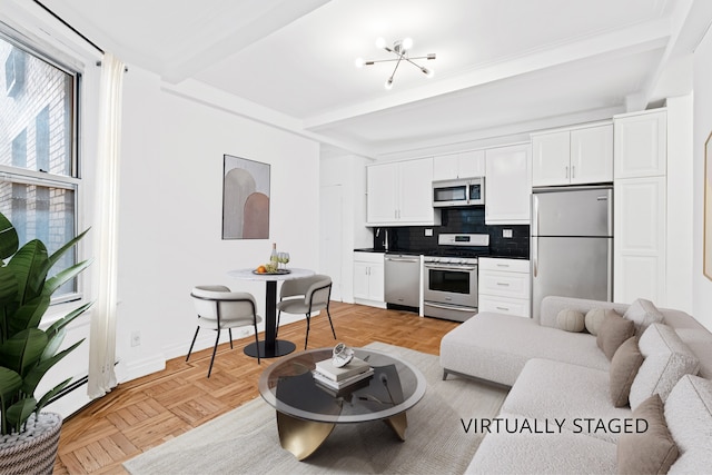 345 W 55th St Unit 7-D, New York City, NY 10019 - living room featuring beam ceiling and baseboards