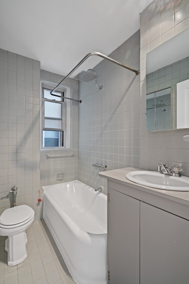 345 W 55th St Unit 7-D, New York City, NY 10019 - bathroom featuring tile walls, tile patterned floors, vanity, toilet, and shower / washtub combination