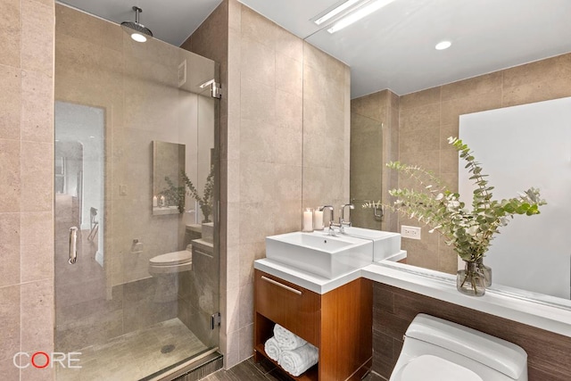 bathroom featuring sink, tile walls, an enclosed shower, and toilet