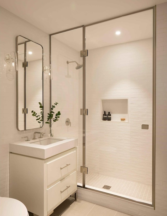 full bathroom featuring a stall shower and vanity