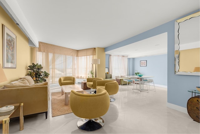 living room featuring tile patterned floors and baseboards