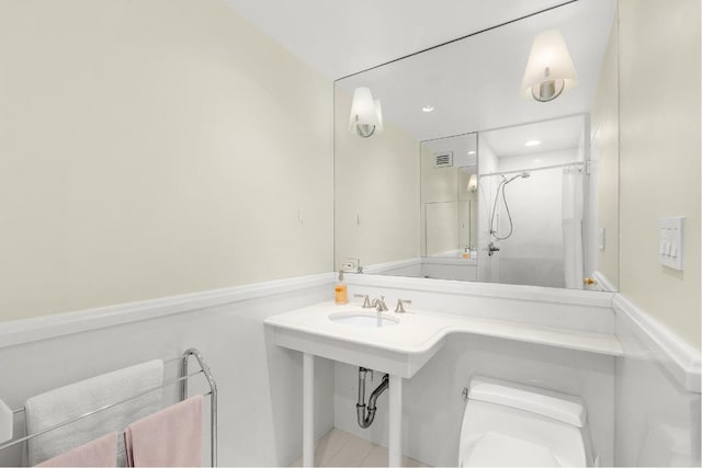 bathroom featuring sink, toilet, and walk in shower