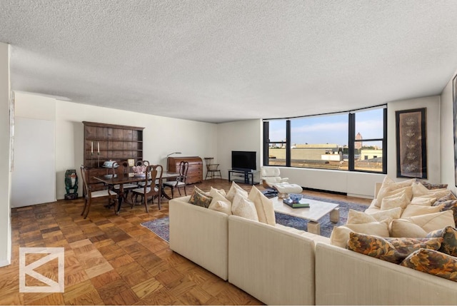 living room with parquet flooring and a textured ceiling