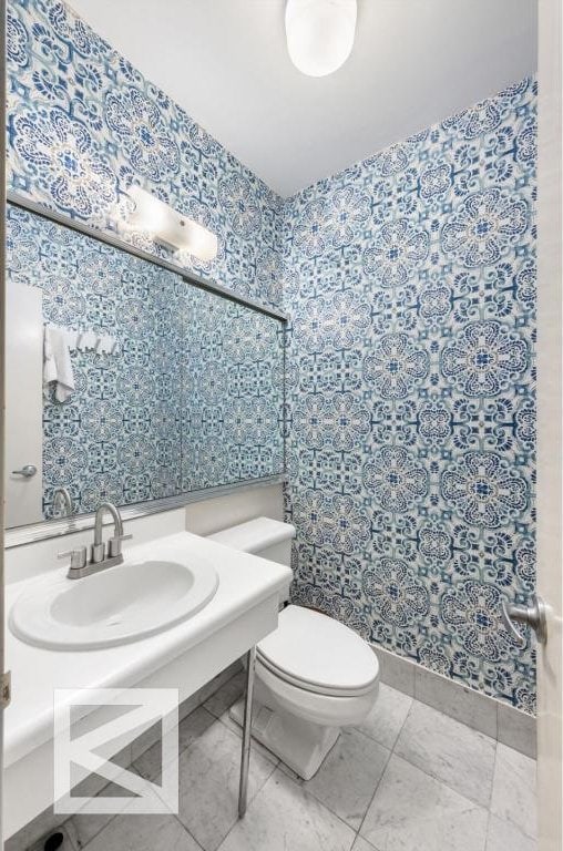 bathroom featuring tile patterned flooring, sink, and toilet