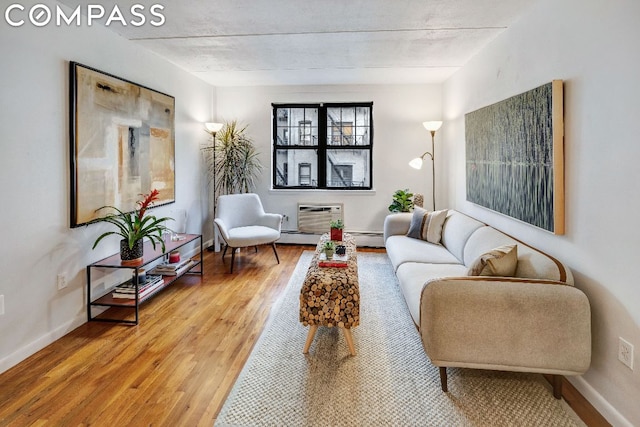 living room with wood-type flooring and baseboard heating