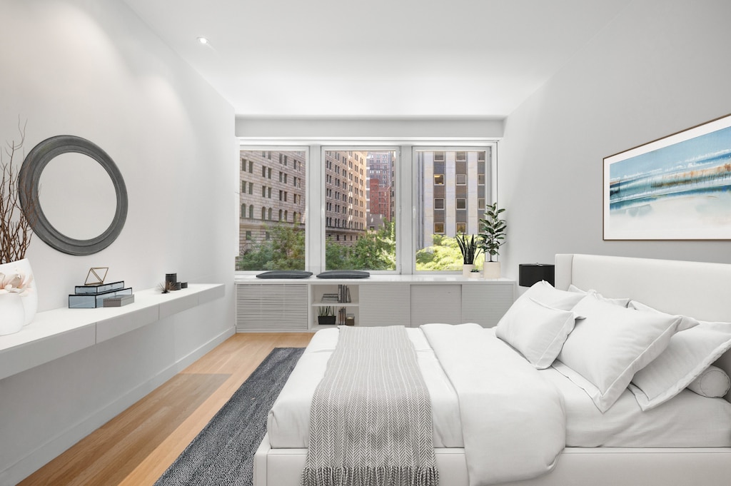 bedroom with wood finished floors and baseboards